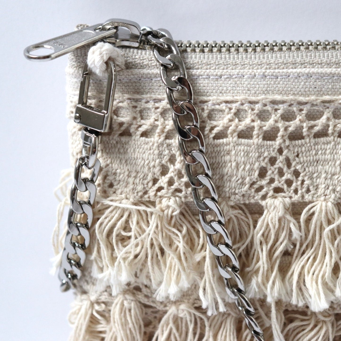 Detailed image of crossbody purse with silver chain crossbody strap