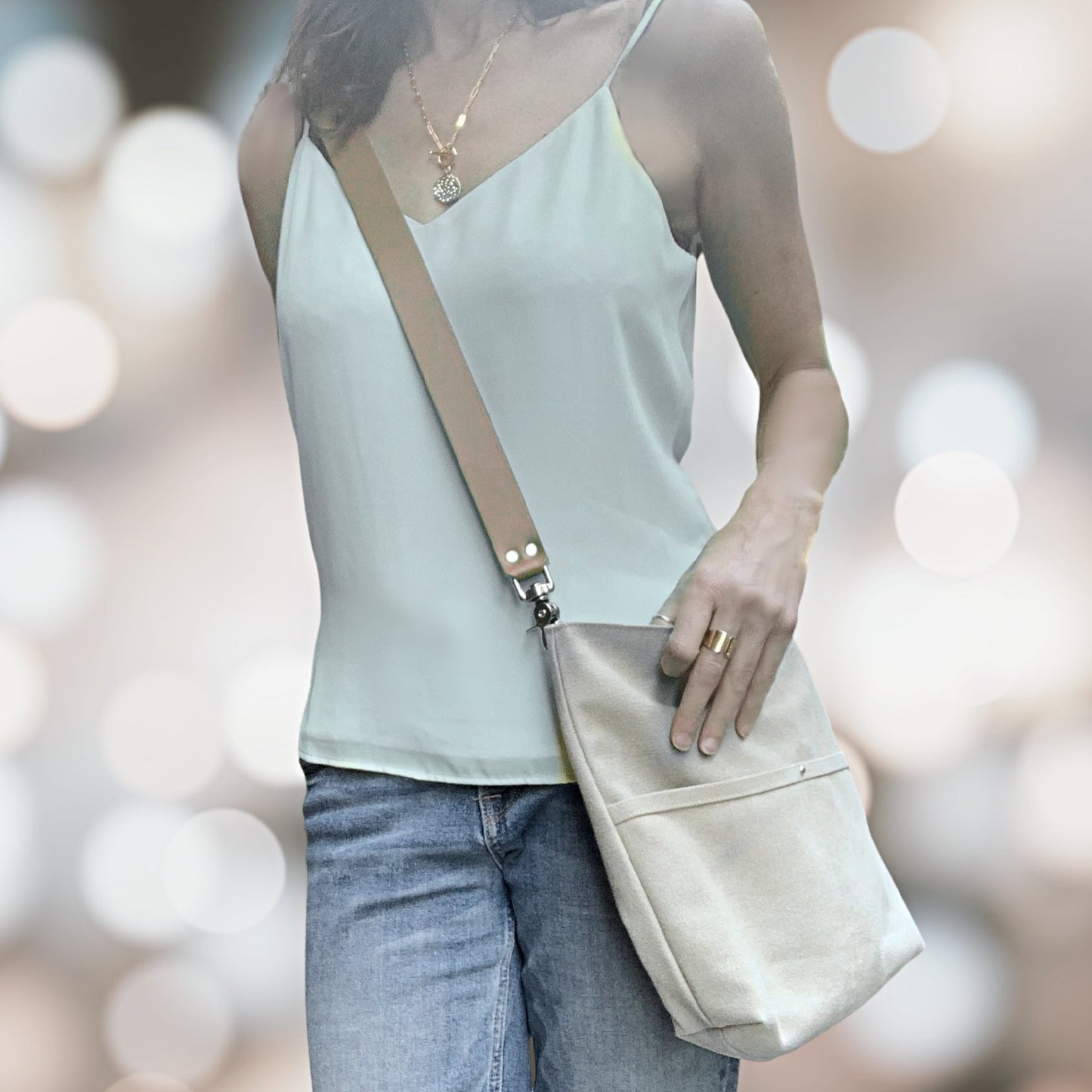 lifestyle image of model with canvas crossbody purse