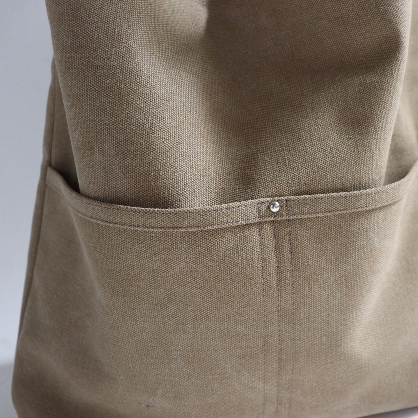 Close up detail of khaki canvas bag with faded vintage style