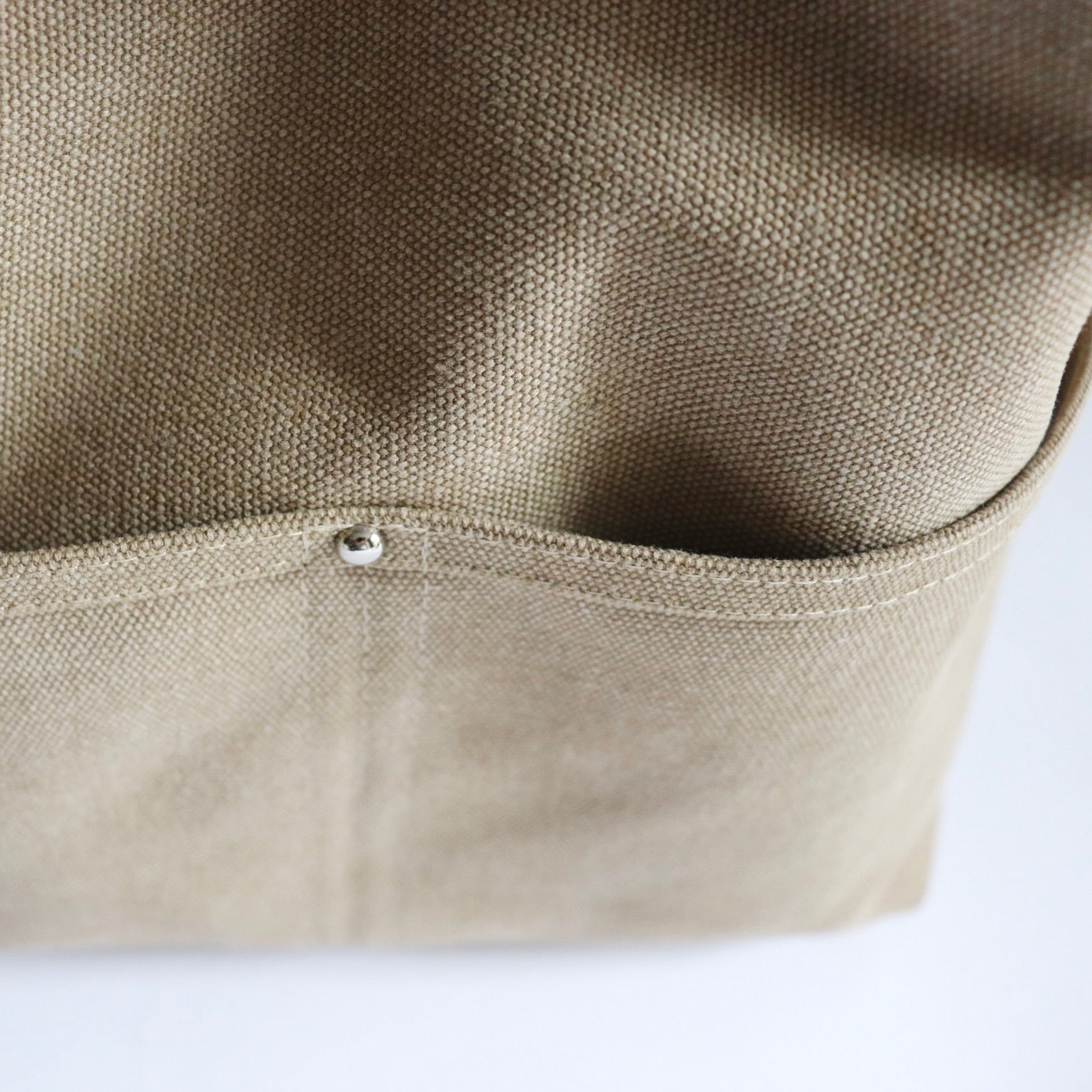 Close up detail of khaki canvas hobo bag