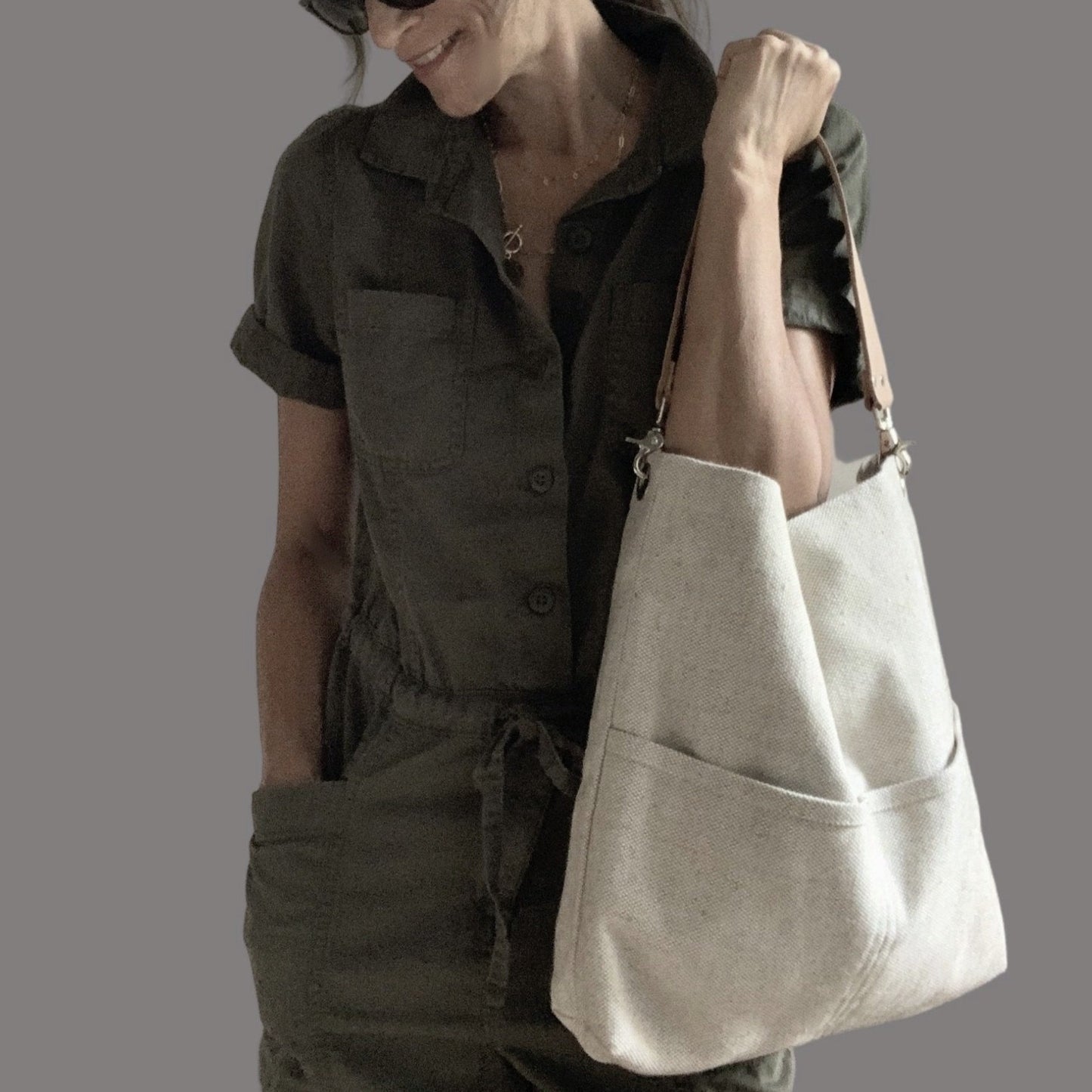 lifestyle photo of model holding large woven shoulder bag