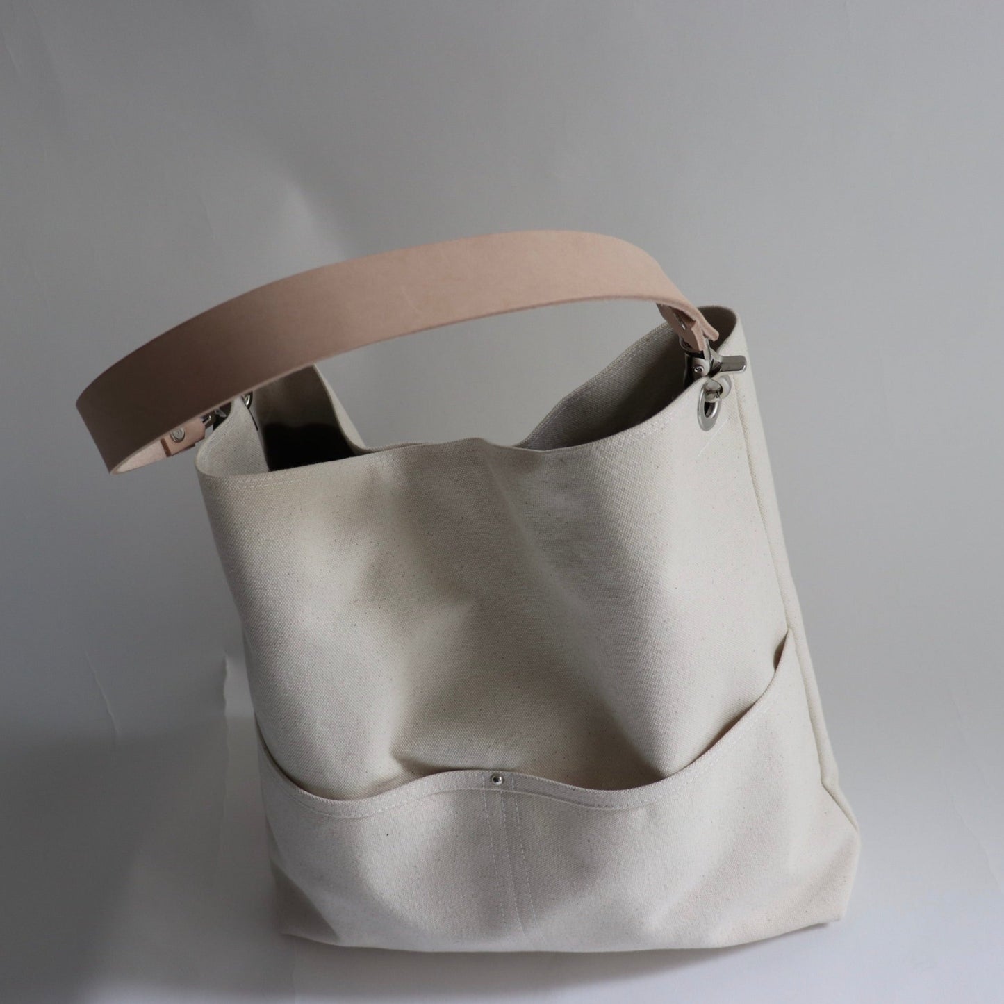 top view of canvas bucket bag with front pockets